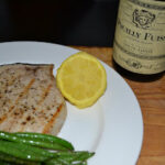 Simply grilled swordfish steaks served with sauteed green beans and lemon.