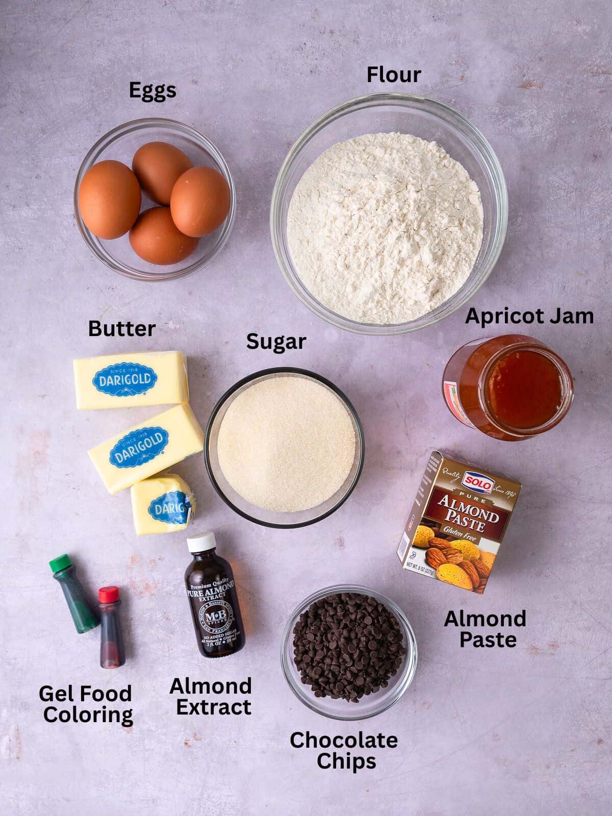 Ingredients for Italian rainbow cookies including almond paste, chocolate chips, sugar and almond extract.