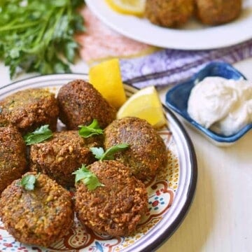 Learn how to make homemade Lebanese falafel recipe with dried chickpeas, loads of fresh herbs and warm spices. Serve with creamy tahini yogurt.