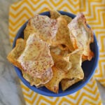 Homemade taro chips piled in a blue bowl.