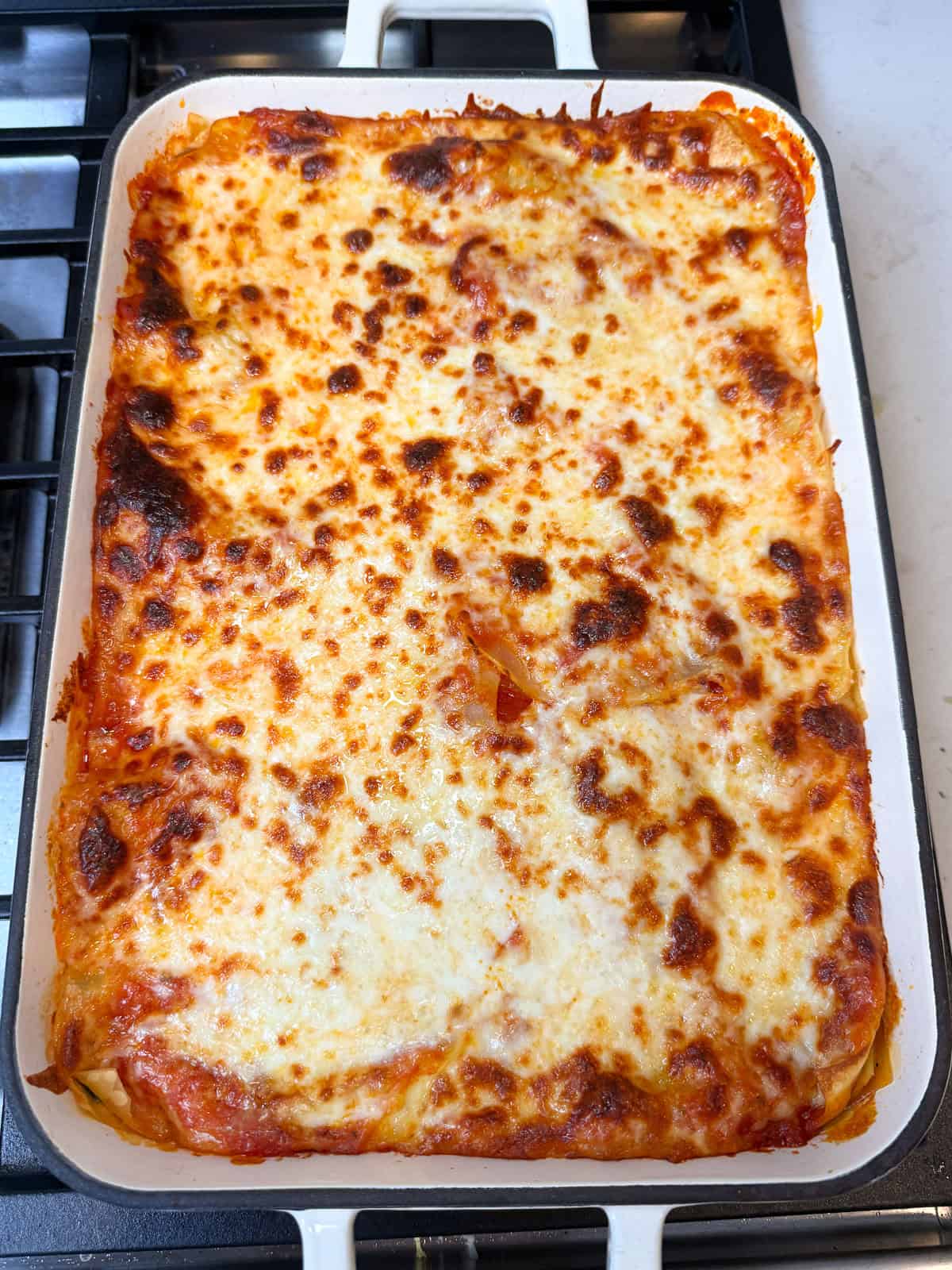 Bake the vegetarian lasagna until the cheese is melted and top is bubbly.