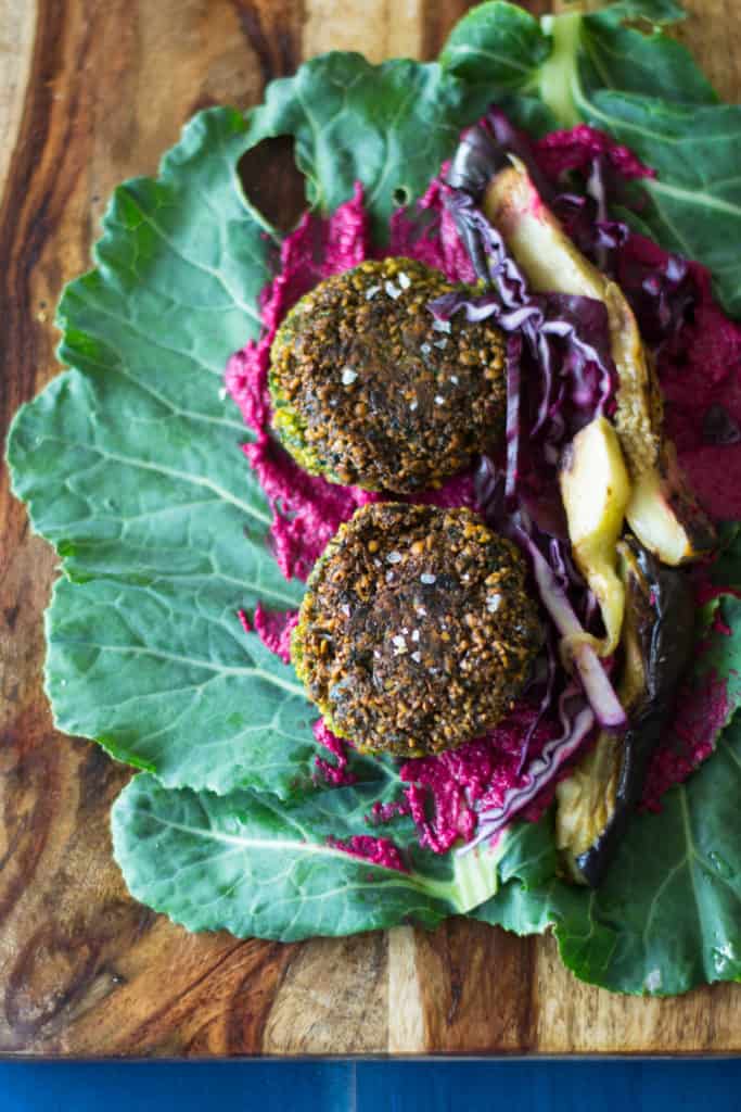 Falafel Collard Wrap with all the fillings including grilled eggplant, creamy tahini sauce, beet hummus and fresh cabbage!