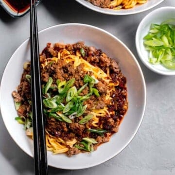 Dan dan noodles are cooked noodles tossed with a spicy pepper oil and ground pork.