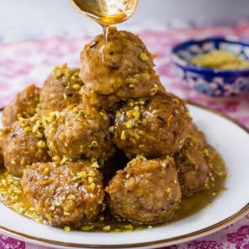 Baklava Bimuelos: Sephardic Passover Matzo Donuts Fried and Doused in a Thick Rose Water Syrup with Pistachios.