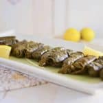 Step by step recipe on how to make Turkish stuffed grape leaves. Filled with meat and rice and simmered with layers of fresh lemon.
