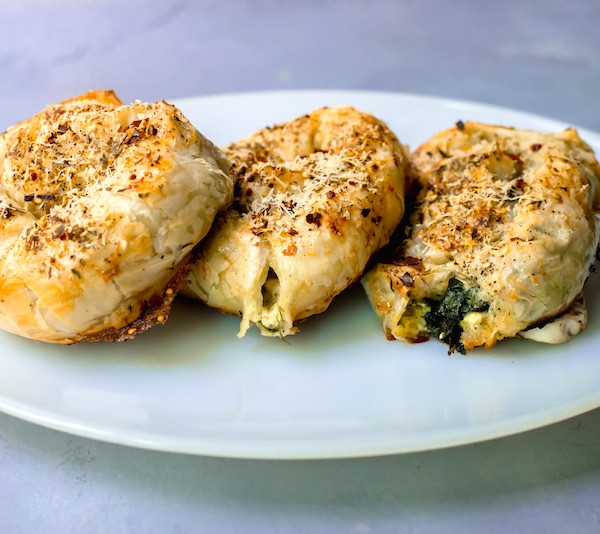 Savory round borek are filled with wilted greens, sauteed shallots and cheese all rolled up in a delicious savory pastry.