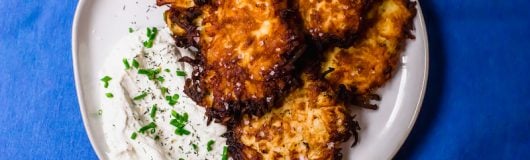 A play on the traditional potato latkes, these salt and vinegar potato latkes have a hint of sourness from the vinegar and a healthy sprinkle of sea salt. Serve along side onion and chive sour cream for a fun play on latkes.