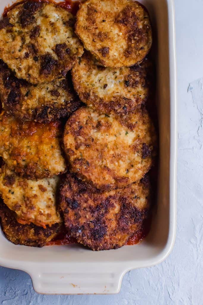 Layer fried eggplant parmesan with marinara sauce for a delicious Italian dinner.