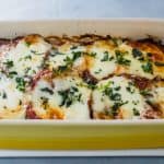 Classic Eggplant Parmesan recipe is a favorite comfort food. Peeled and fried eggplant is generously flavored with fresh herbs and Parmesan cheese that is then baked with layers of marinara and mozzarella.