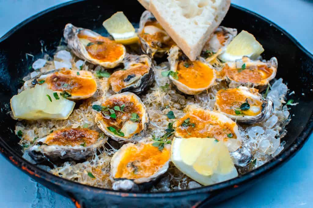 Inspired by a New Orleans favorite, these charbroiled oysters are cooked with paprika herb butter and topped with Parmesan cheese and lemon. 