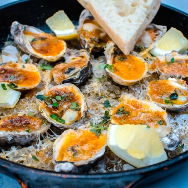 Inspired by a New Orleans favorite, these charbroiled oysters are cooked with paprika herb butter and topped with Parmesan cheese and lemon.