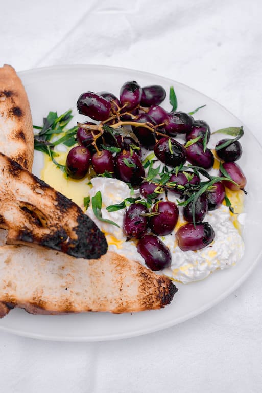 Sweet and smoky grilled grapes with burrata and tossed with fruity olive oil and elegant tarragon. Serve with crusty bread for an impressive and easy appetizer.