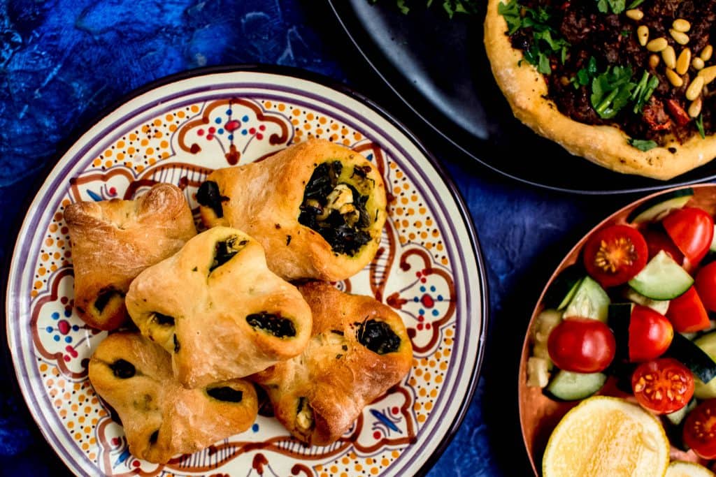 Inspired by the savory Lebanese meat pies called sfeeha, these open faced pies are topped with spiced beef or lamb and garnished with lemon and fresh herbs.