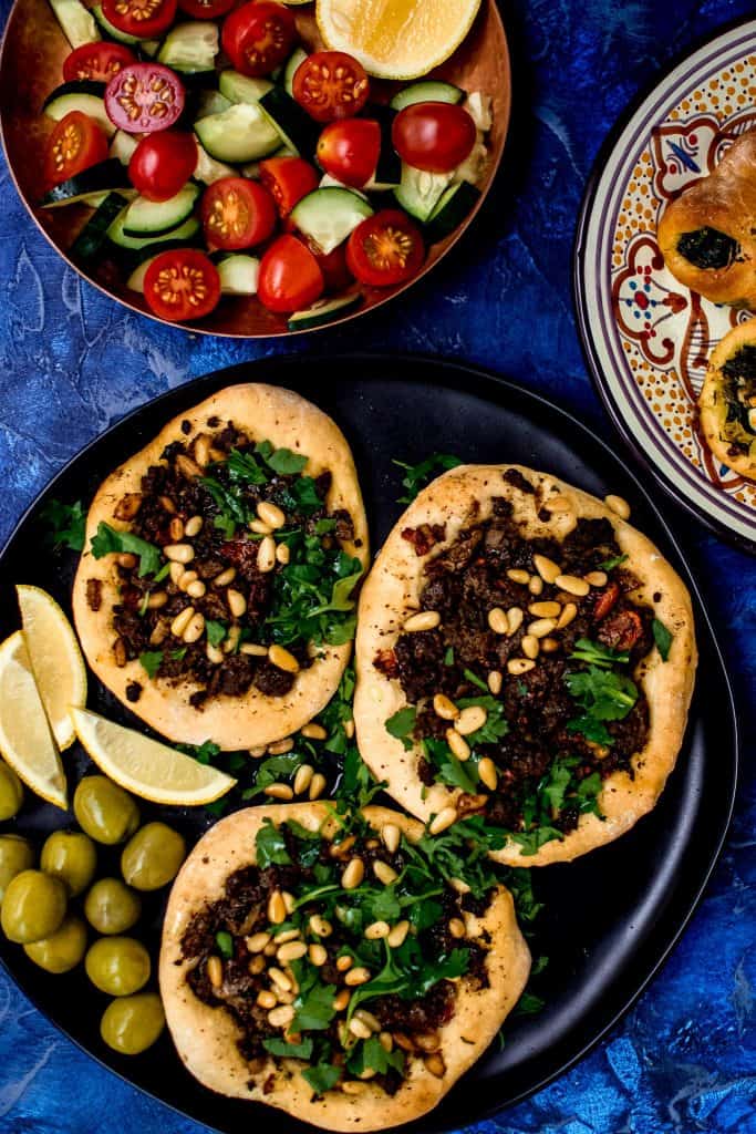 Inspired by the savory Lebanese Meat Pies called sfeeha, these open faced pies are topped with spiced lamb or beef and garnished with bright lemon and fresh herbs.