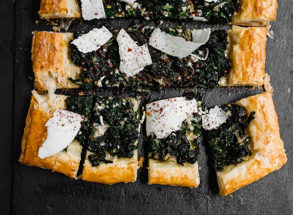 The perfect use for an abundance of garden greens. Sauteed Swiss chard is layered on top of butter puff pastry and finished with tangy sumac and strips of ricotta salata cheese. 