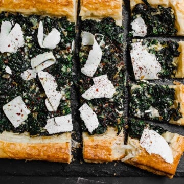 The perfect use for an abundance of garden greens. Sauteed Swiss chard is layered on top of butter puff pastry and finished with tangy sumac and strips of ricotta salata cheese.