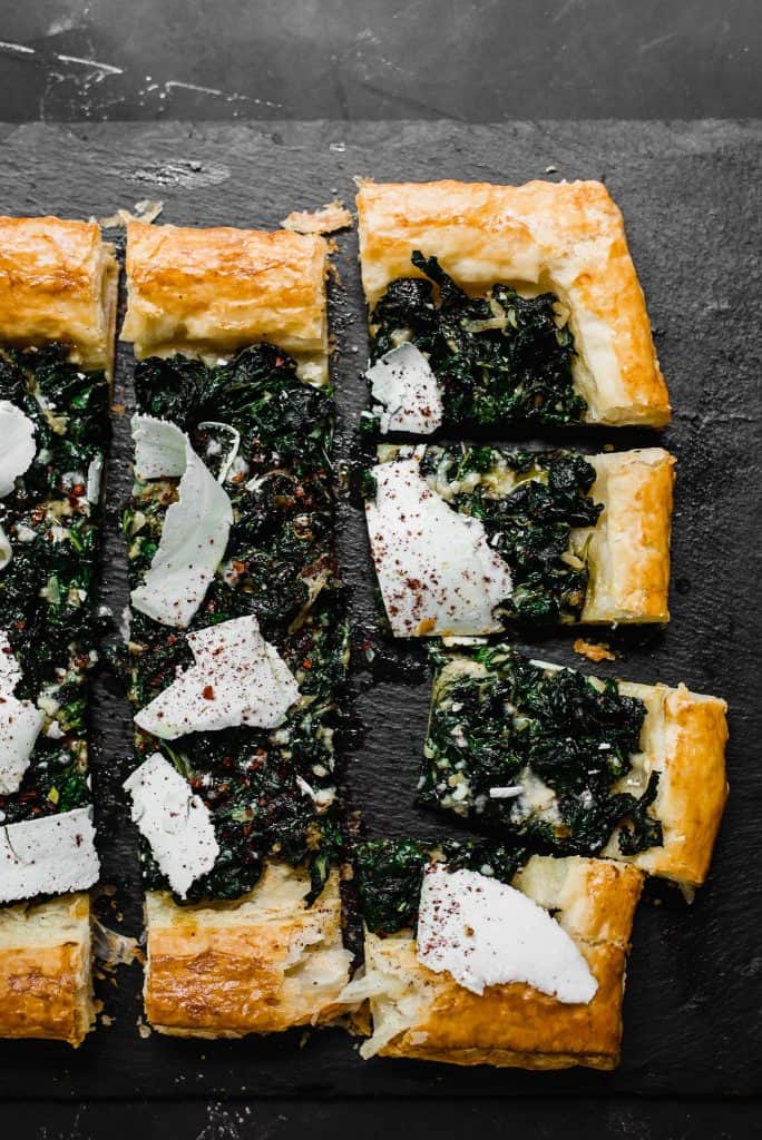 The perfect use for an abundance of garden greens. Sauteed Swiss chard is layered on top of butter puff pastry and finished with tangy sumac and strips of ricotta salata cheese.