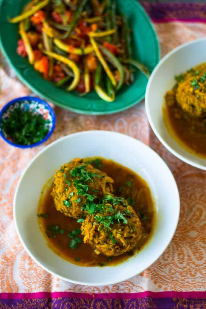 Koofteh are hearty and flavorful Persian meatballs mixed with loads of aromatic herbs, split peas and rice that are then simmered in a turmeric tomato broth.