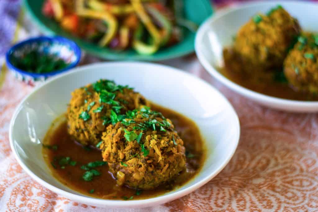 Koofteh are hearty and flavorful Persian meatballs mixed with loads of aromatic herbs, split peas and rice that are then simmered in a turmeric tomato broth.