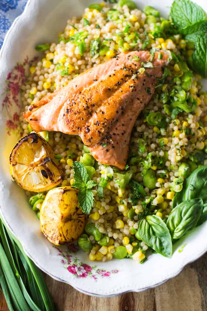 Simply charred salmon served over Israeli couscous and fava beans tossed in a bright lemon vinaigrette are what weeknight dinners are made for. 