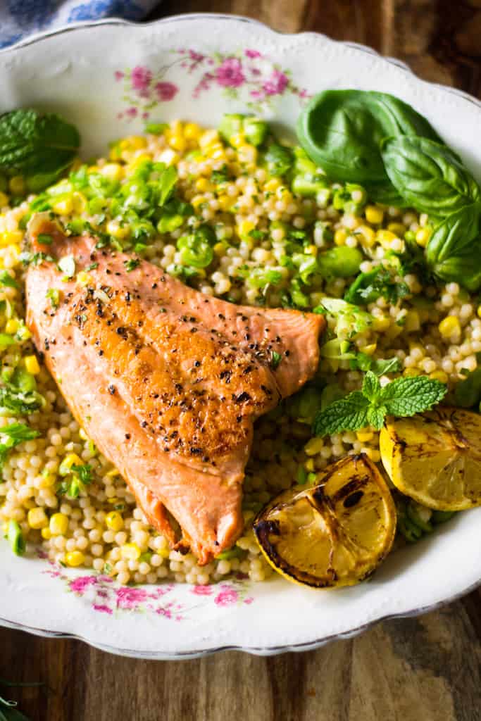 Simply charred salmon served over Israeli couscous and fava beans tossed in a bright lemon vinaigrette are what weeknight dinners are made for. 