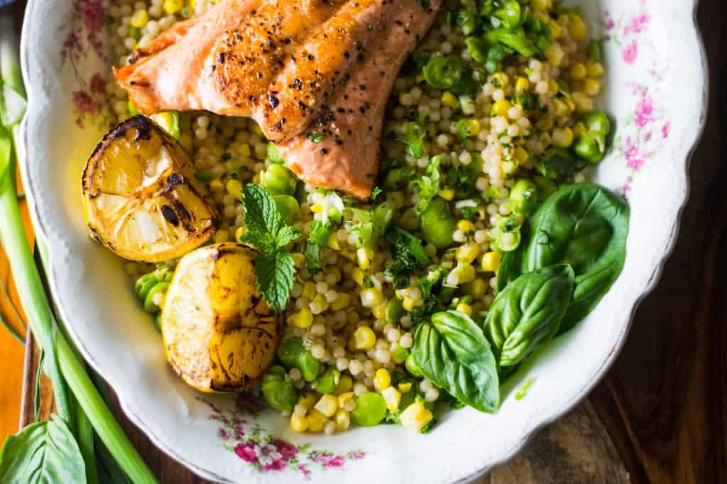 Simply charred salmon served over Israeli couscous and fava beans tossed in a bright lemon vinaigrette are what weeknight dinners are made for. 