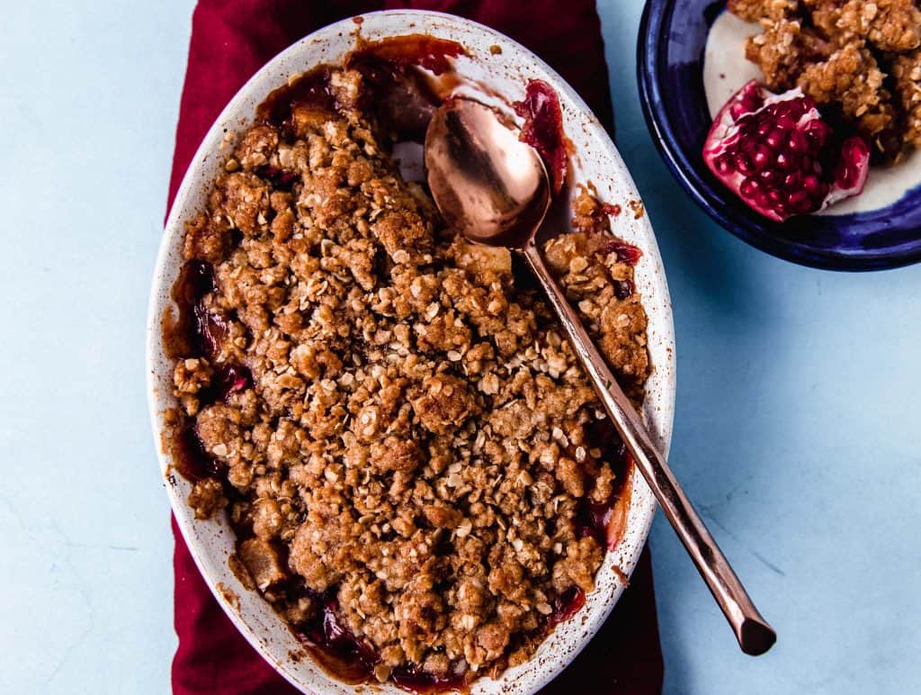 Pear and pomegranate crumble flavored with orange zest and vanilla paste is a simple and impressive weeknight dessert.