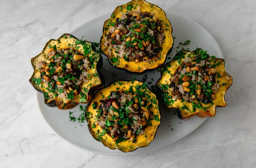 Acorn squash is stuffed with a Lebanese rice mixture called hashweh that is layered with warm spices of cinnamon, ground beef and tart cranberries. 