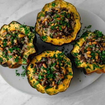 Acorn squash is stuffed with a Lebanese rice mixture called hashweh that is layered with warm spices of cinnamon, ground beef and tart cranberries.