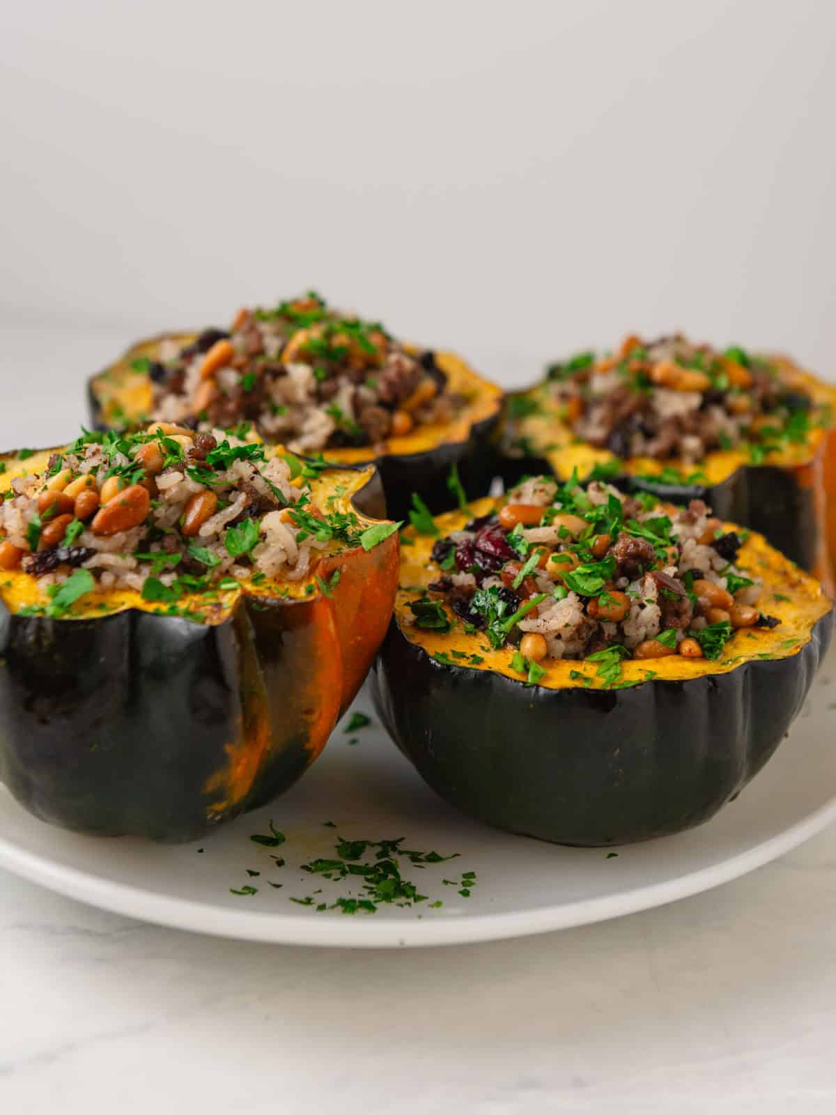 Stuffed acorn squash with a spiced rice and ground meat mixture called hashweh with pine nuts and dried cranberries. 