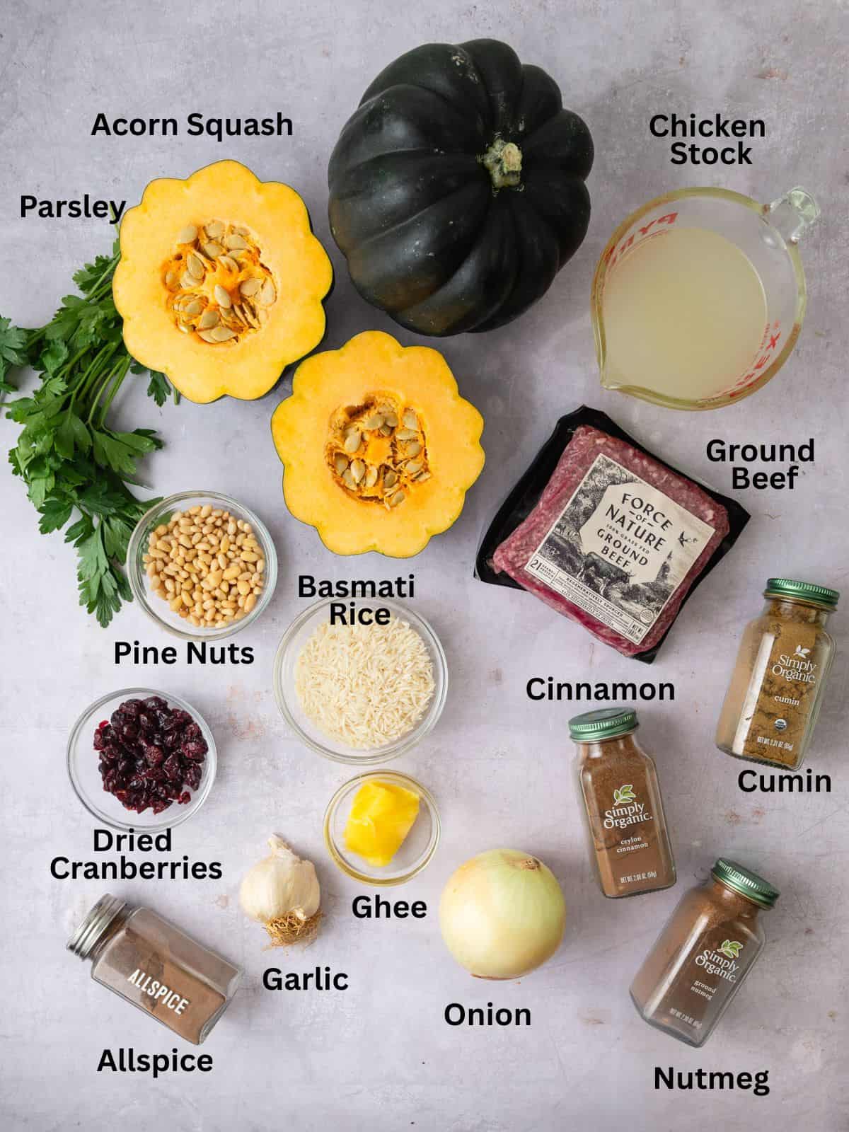 Ingredients for stuffed acorn squash with ground beef, pine nuts, rice and spices.