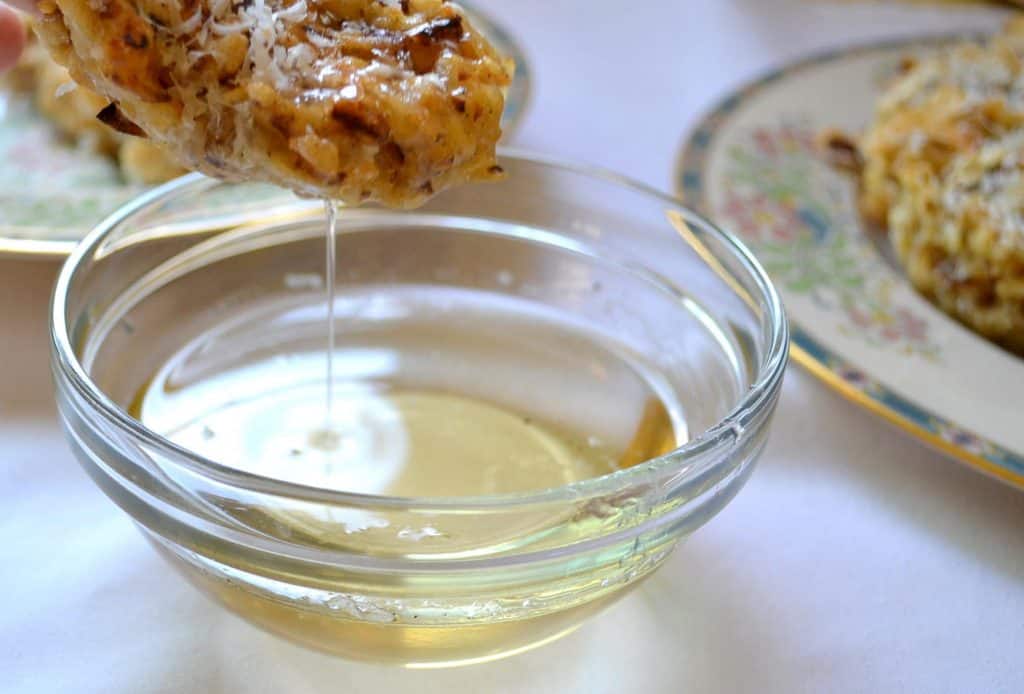 A Sephardic family heirloom, Passover bimuelos are a fried pancake with matzo, eggs and Parmesan cheese dipped in a sweet simple syrup.