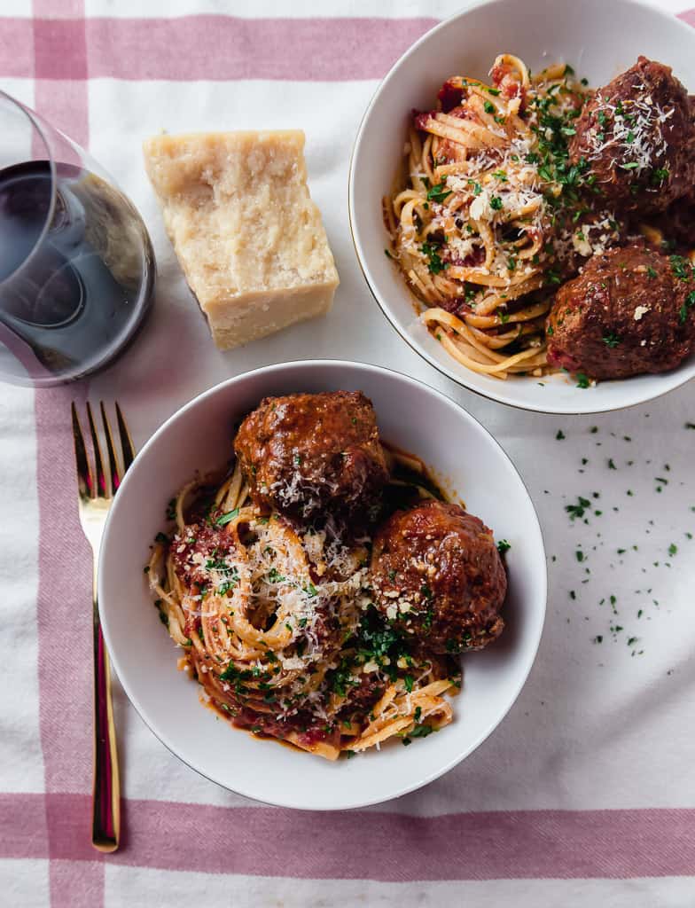 Homemade meatballs with Sunday gravy is a true labor of love. Meatballs are mixed with three meats and seasoned with flavorful aromatics which are then simmered in marinara for hours making them incredibly tender and flavorful. 