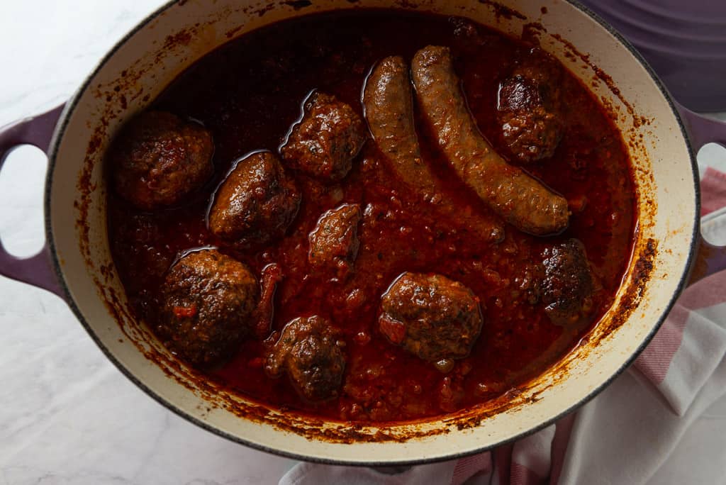 Homemade meatballs with Sunday gravy is a true labor of love. Meatballs are mixed with three meats and seasoned with flavorful aromatics which are then simmered in marinara for hours making them incredibly tender and flavorful. 