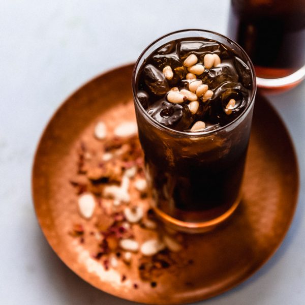 A floral and refreshing Middle Eastern drink inspired from Lebanon, Jallab is made with date molasses, a touch of rose mater and topped with pine nuts.
