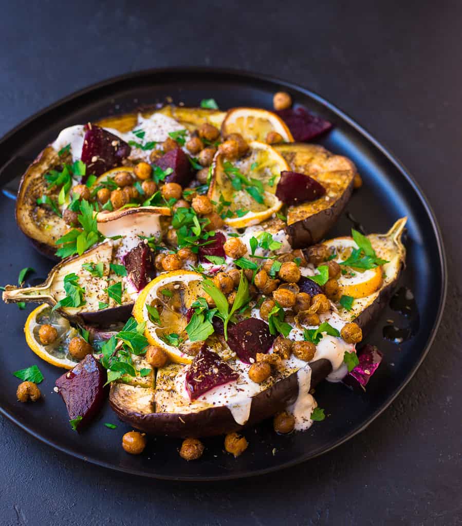 Roasted eggplant is topped with creamy tahini, sweet beets and roasted chickpeas that is hearty enough as a Mediterranean vegetarian entree.