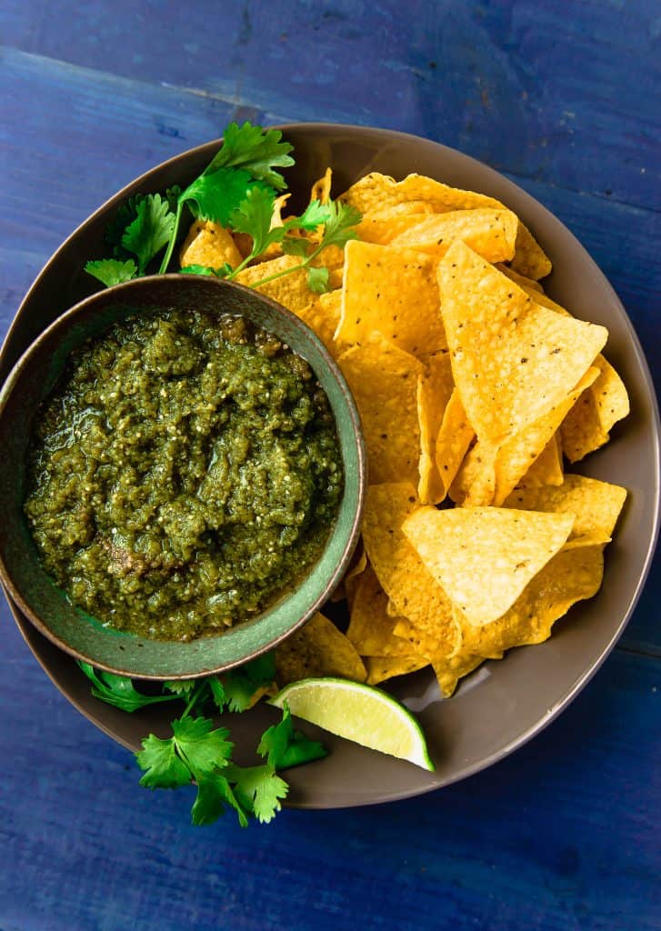 Roasted tomatillo salsa couldn't be easier. A bit brighter than tomato salsa, this recipe roasts the tomatillos and onions creating a sweet and bright flavor. Once roasted, blend with fresh cilantro, lime juice and a touch of honey to bring it all together. 