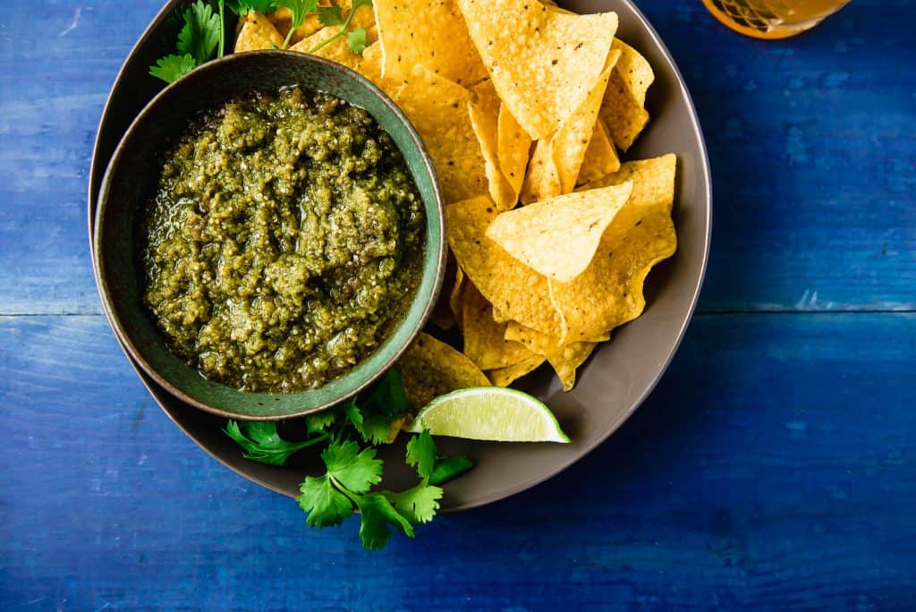 Roasted tomatillo salsa couldn't be easier. A bit brighter than tomato salsa, this recipe roasts the tomatillos and onions creating a sweet and bright flavor. Once roasted, blend with fresh cilantro, lime juice and a touch of honey to bring it all together. 