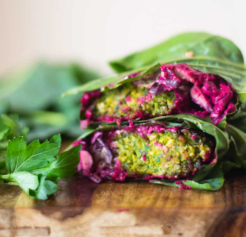 Falafel Collard Wrap with all the fillings including grilled eggplant, creamy tahini sauce, beet hummus and fresh cabbage!