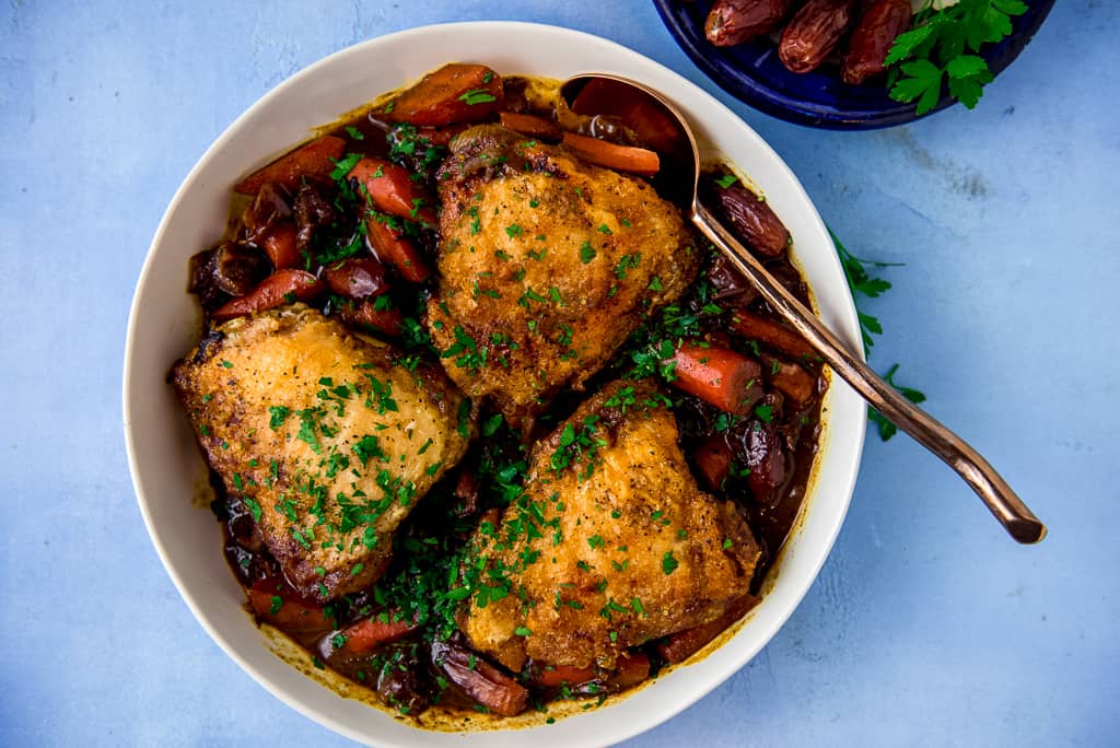 Braised chicken with dates, red wine and saffron is a gorgeous main course with layers of bold, slightly sweet and savory flavors.