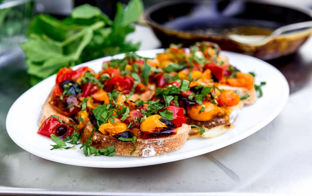 When tomatoes are at their peak, roasted tomato bruschetta is on the menu! Served over crostini, fresh basil and fruity olive oil. 