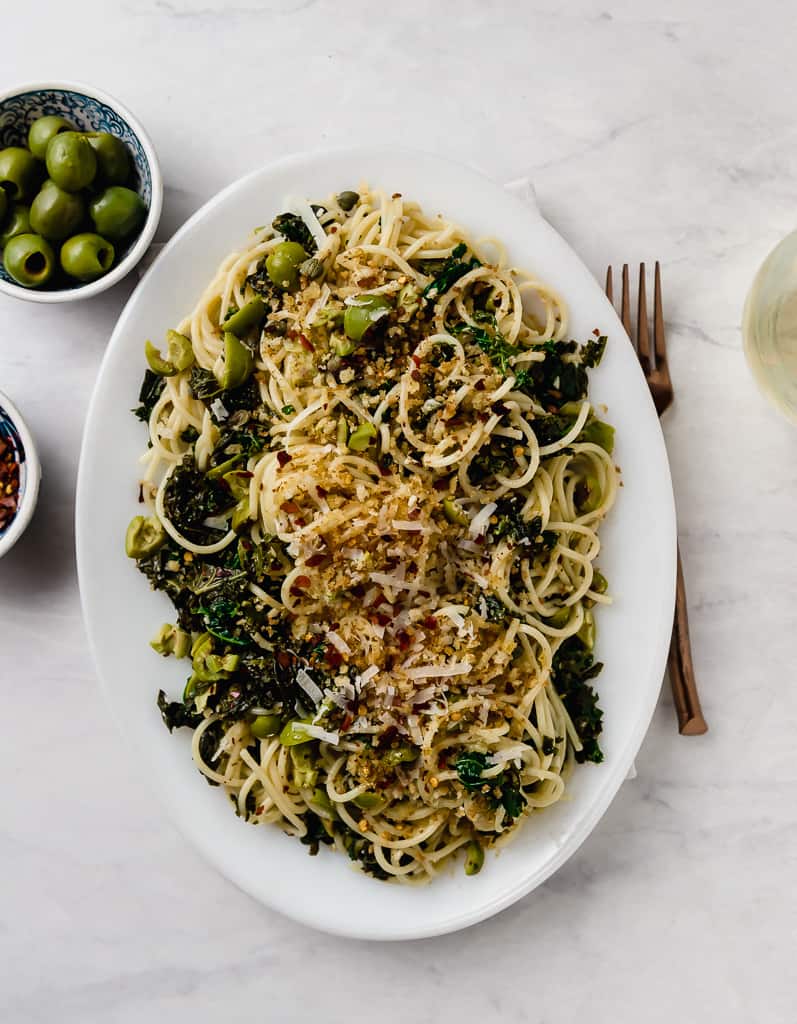 Kale pasta with capers and olives is a lighter version of puttanesca pasta, with buttery castelveltrano olives and topped with toasted panko.