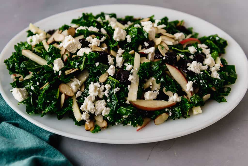 Kale cranberry salad  is tossed with a slightly sweet maple Dijon dressing, dried cranberries, creamy feta, apples and toasted almonds. 