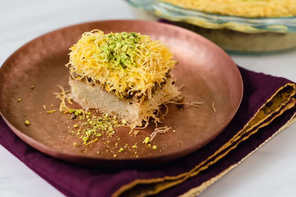 Kadaif AKA kadayif is a Middle Eastern dessert made of shredded phyllo, spiced pistachios and finished with orange blossom simple syrup.