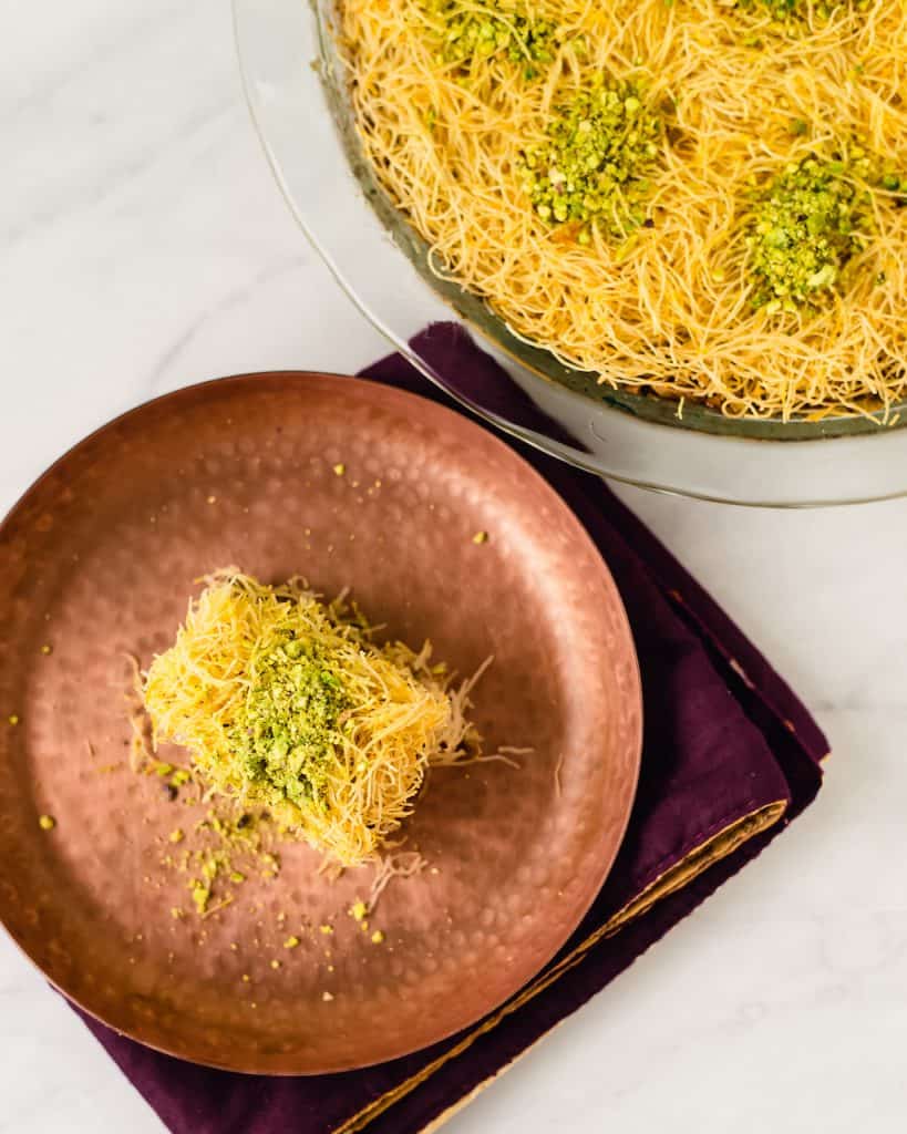 Kadaif AKA kadayif is a Middle Eastern dessert made of shredded phyllo, spiced pistachios and finished with orange blossom simple syrup.