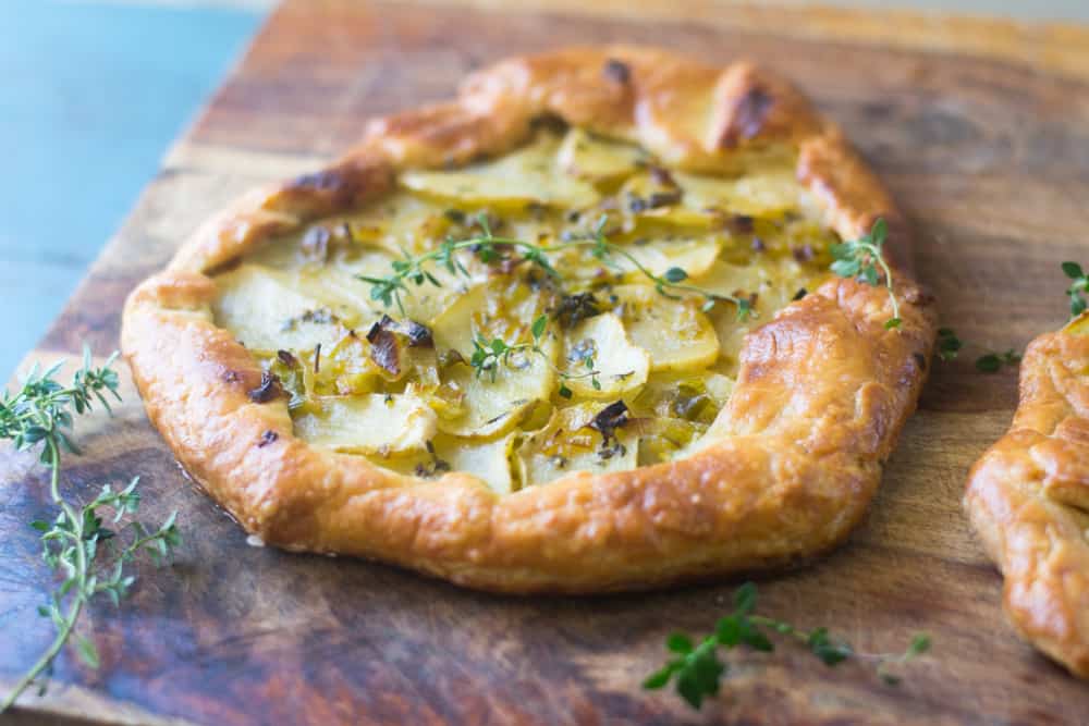 Potato leek tart is an impressive savory tart inspired from the famous potato leek soup, vichyssoise. The savory tart boasts big bold flavors and is layered with a Dijon bechamel, savory leeks and bright fresh thyme. 