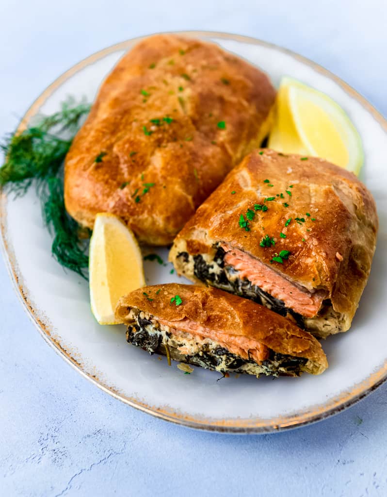 Salmon wellington is a filet of salmon, layered with a creamy spinach mixture and wrapped in puff pastry. The salmon wellington is baked until perfectly golden brown. 