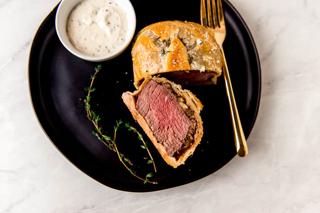 Individual beef wellington is the epitome of a classic, gourmet dish. Small filet mignon steaks are layered in puff pastry with a mushroom chestnut duxelle and a thin layer of paté. The individual beef wellingtons are perfect for a holiday dinner or for a special night in.