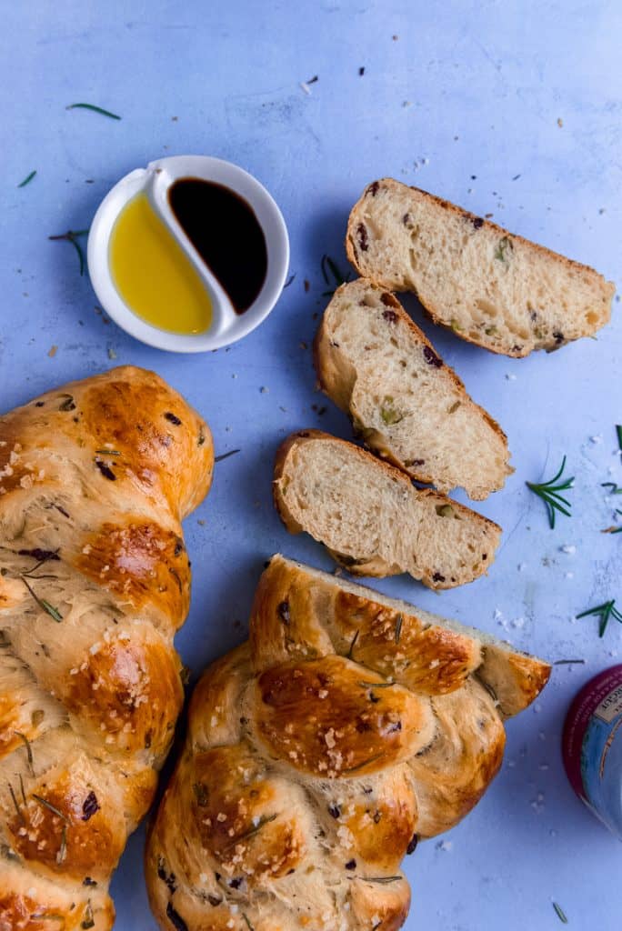 Savory olive oil challah is studded with chopped olives, fresh rosemary and finished with flakey sea salt.