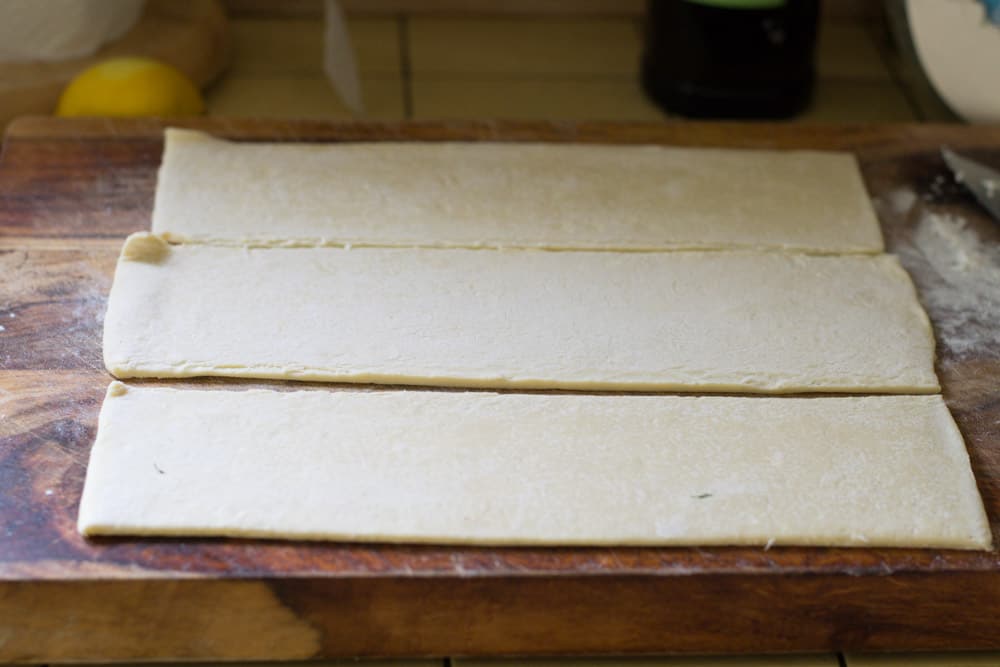 To make mini puff pastry bites, cut puff pastry into 3 long strips then into 12 squares.